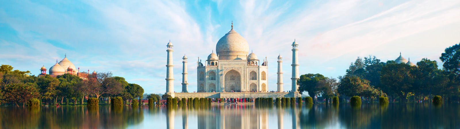 usana in india blue sky and taj mahal with trees and water pond