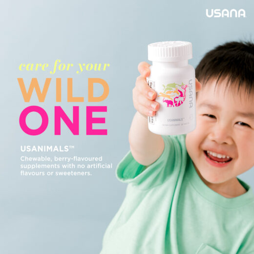 a boy in green shirt holding a usana usanimals bottle